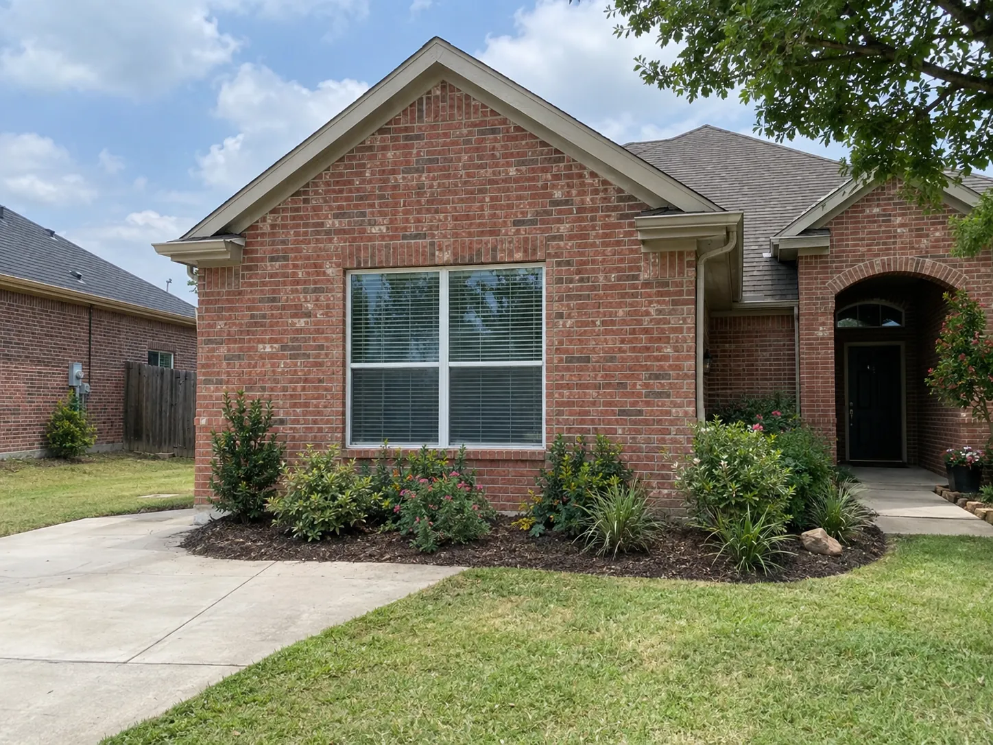 Brick home where the garage door was replaced with a matching wall and window