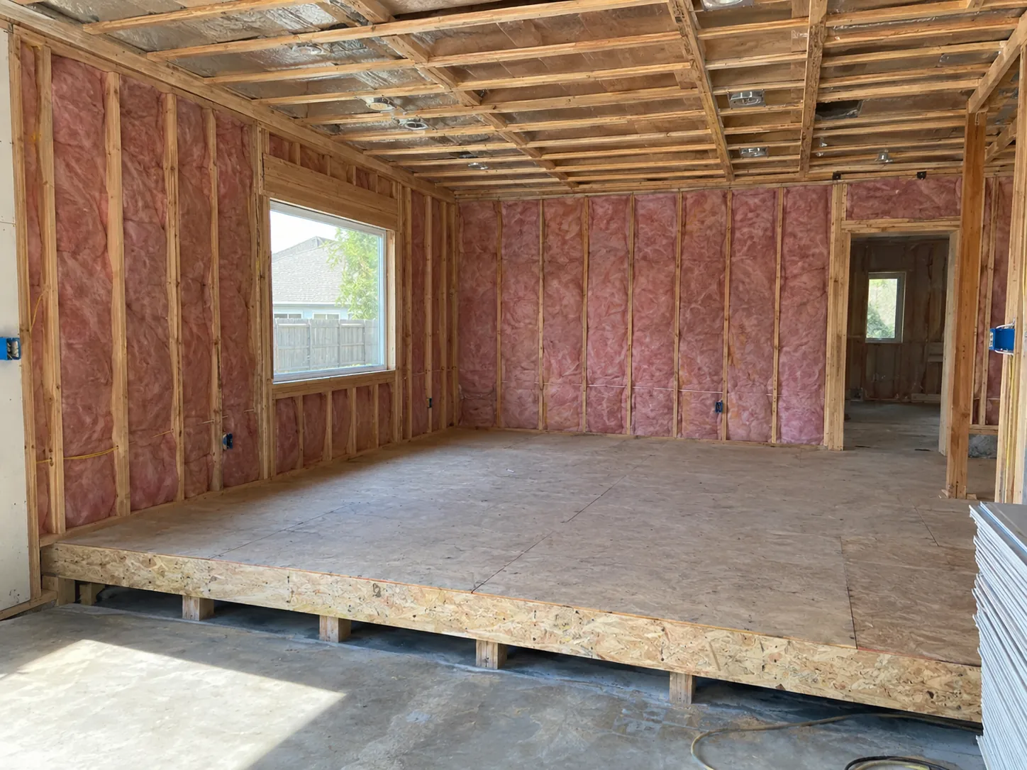 Garage being converted to living space with insulation and a raised subfloor